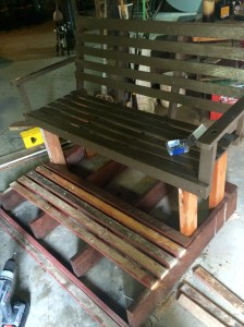 wooden swing being "fitted" with legs from another project